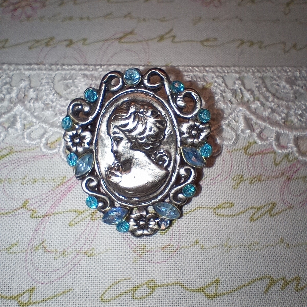 Elegant Silver Tone Cameo Brooch with Blue Accents